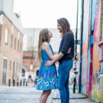 Couples shoot on cobbled street with graffiti in Shoreditch