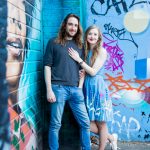 Couple against blue street art
