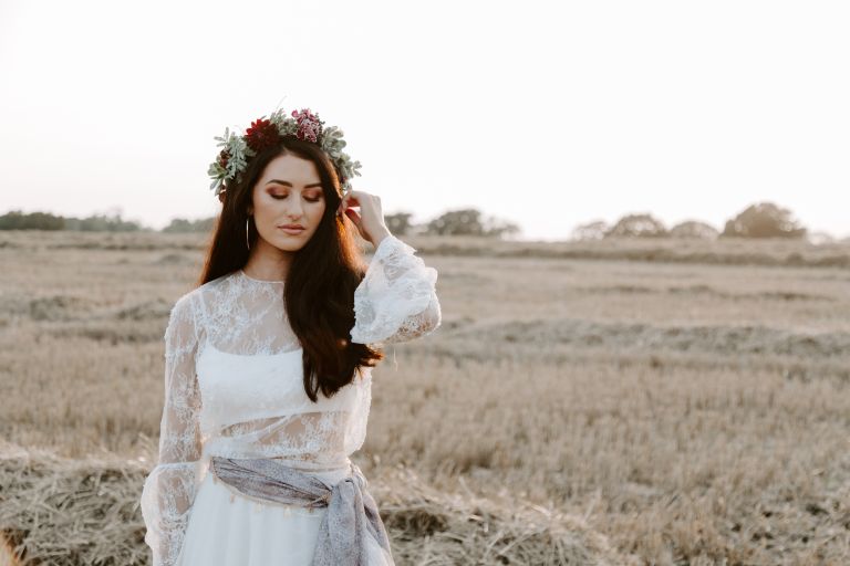 Bohemian bride with a floral crown at sunset