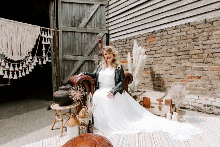 Smiling bride sat in armchair at Lodge Farms