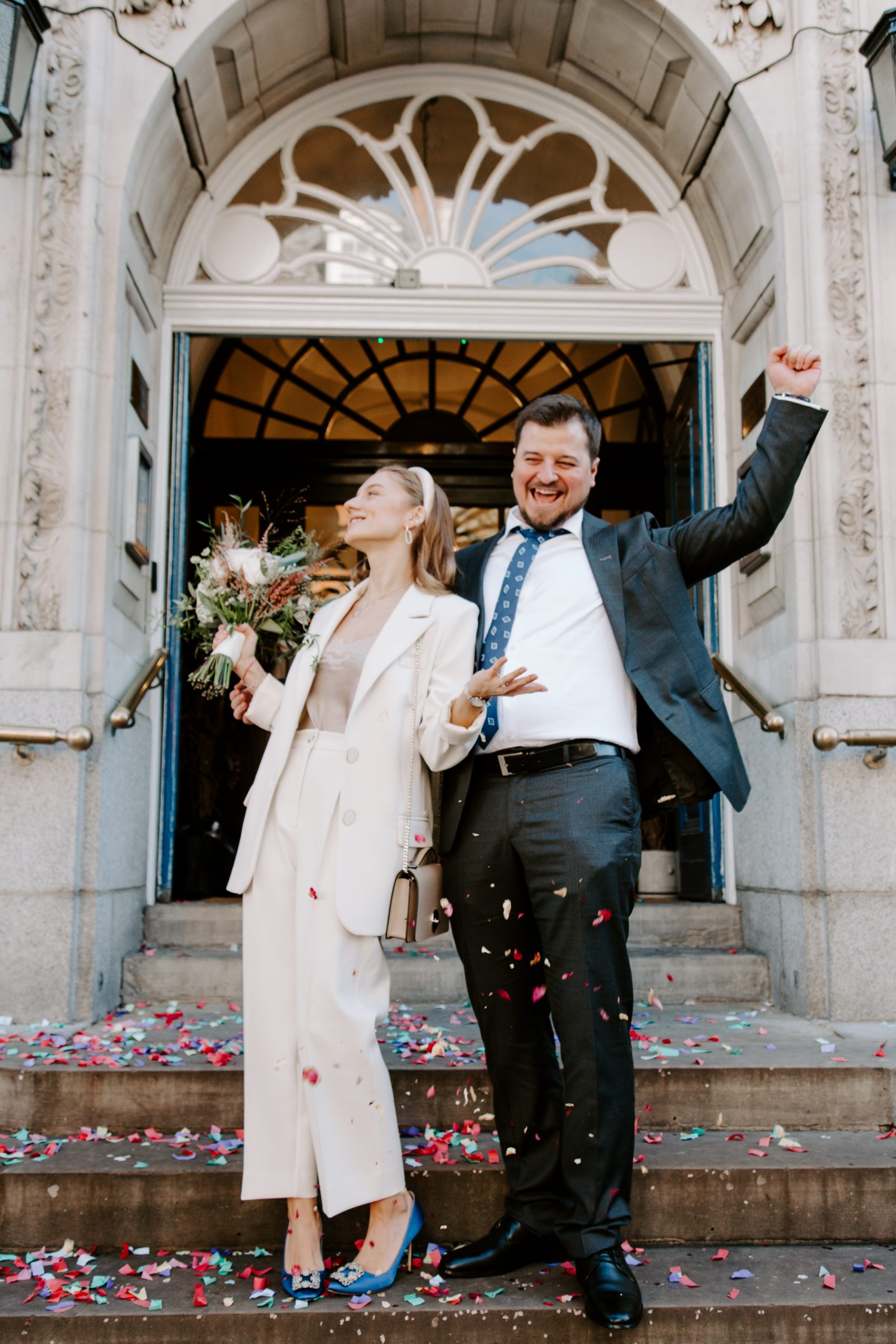 Newly married couple cheering after COVID wedding in London
