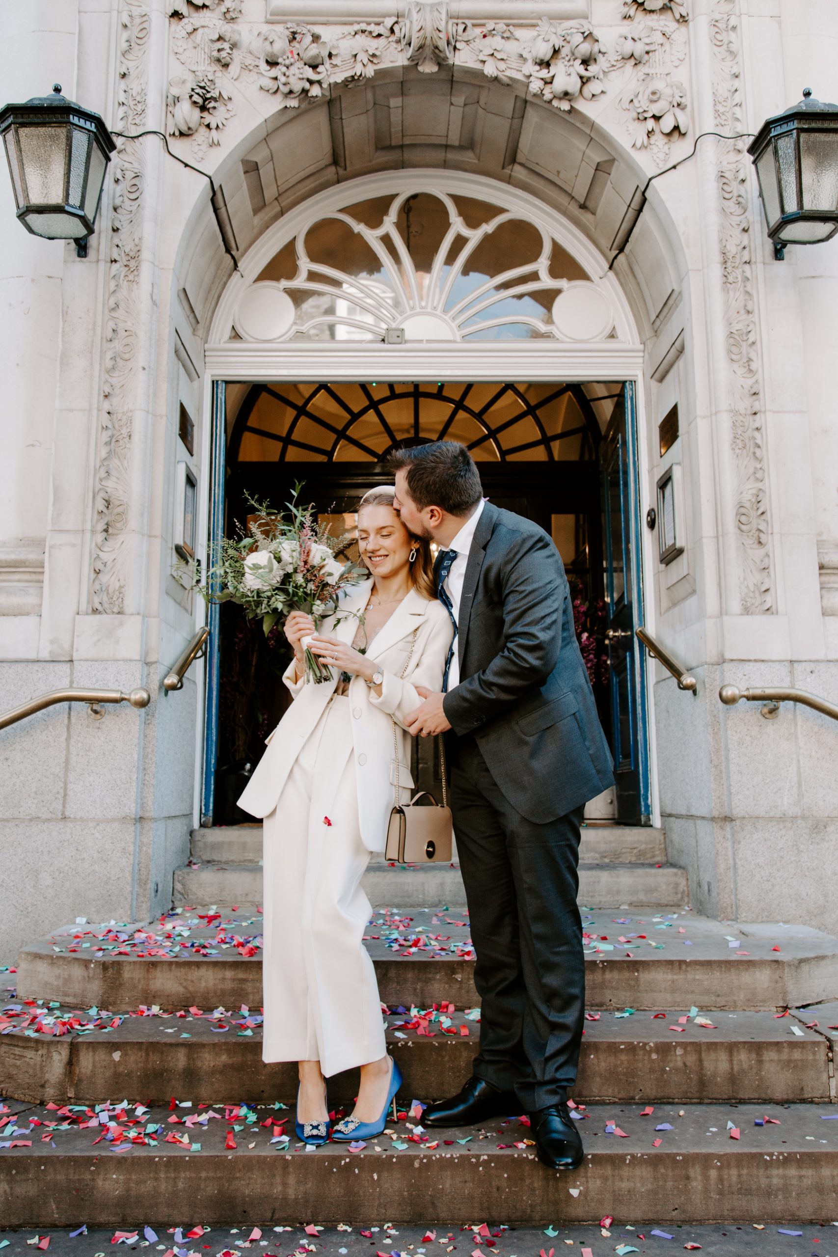Modern Bride and groom on steps of Chelsea Town Hall