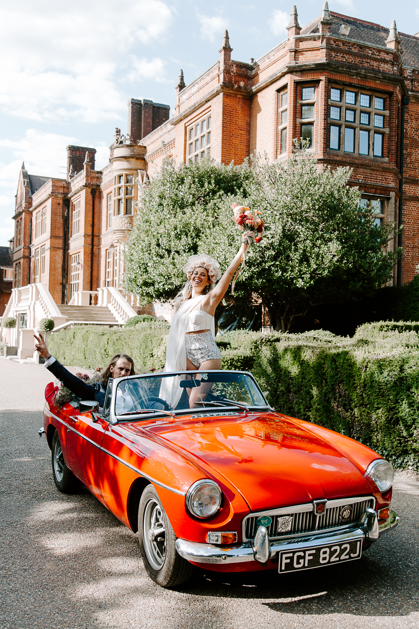 Bride and groom in vintage car at Woldingham School wedding