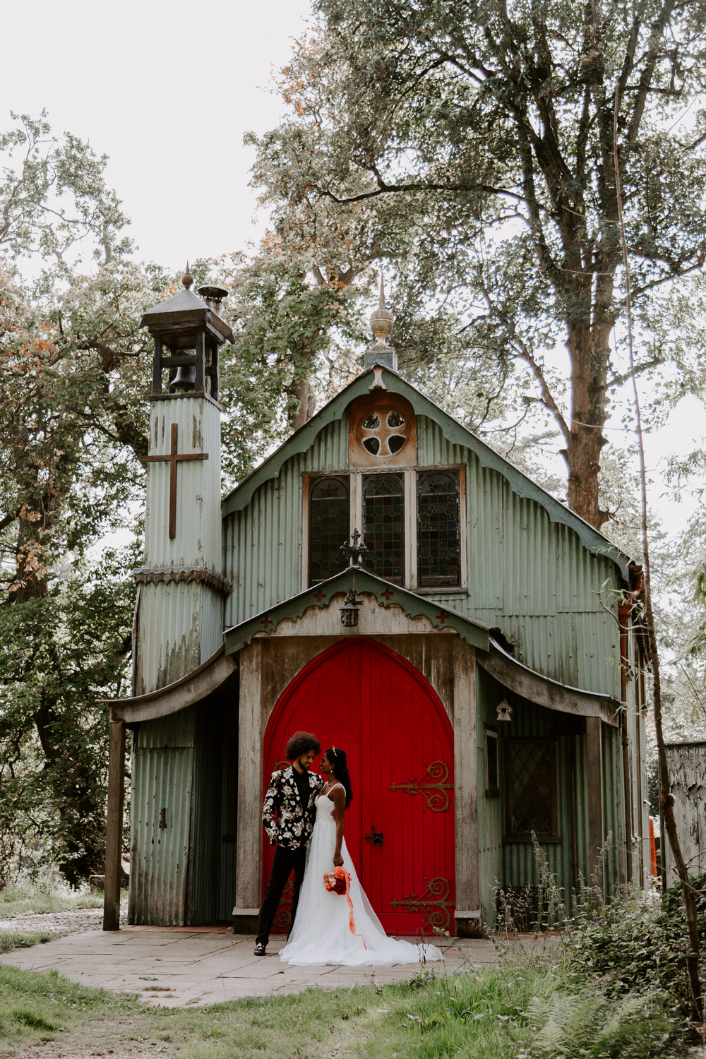 Bride and groom in front of the chapel at Walcot Hall