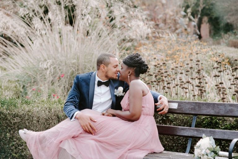 Bride in pink dress kissing groom at Valentines Mansion Redbridge 
