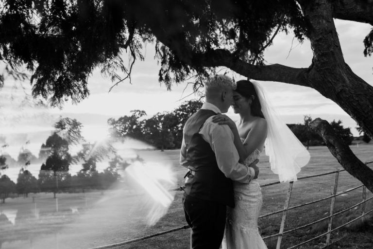 Black and white wedding portraits in the grounds of Gosfield Hall at sunset. We used my prism to create a shimmery effect under this tree at this Essex wedding venue. 