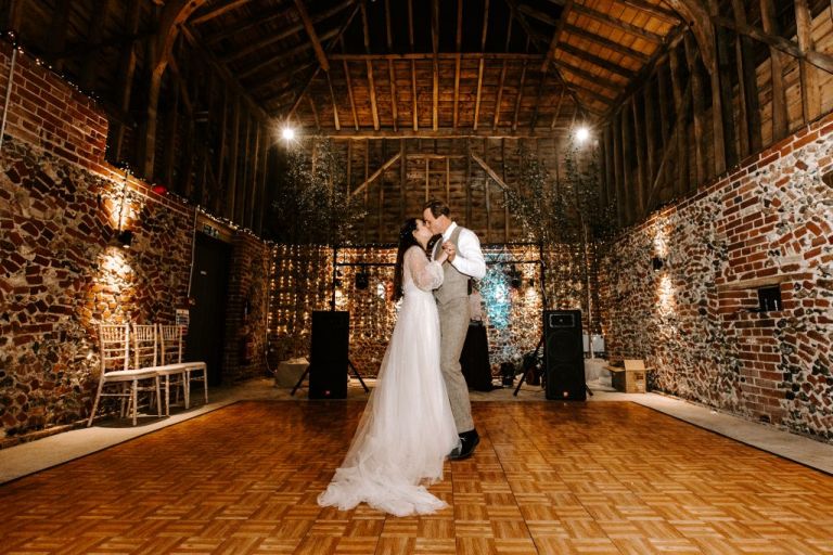 A cosy first dance at the rustic Wedding Barn at Old Hall wedding venue in Cambridgeshire. 
